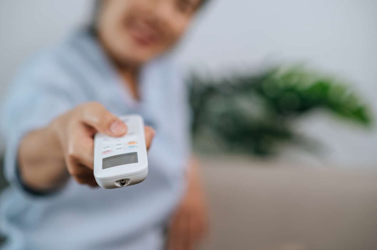 woman turning on the ac