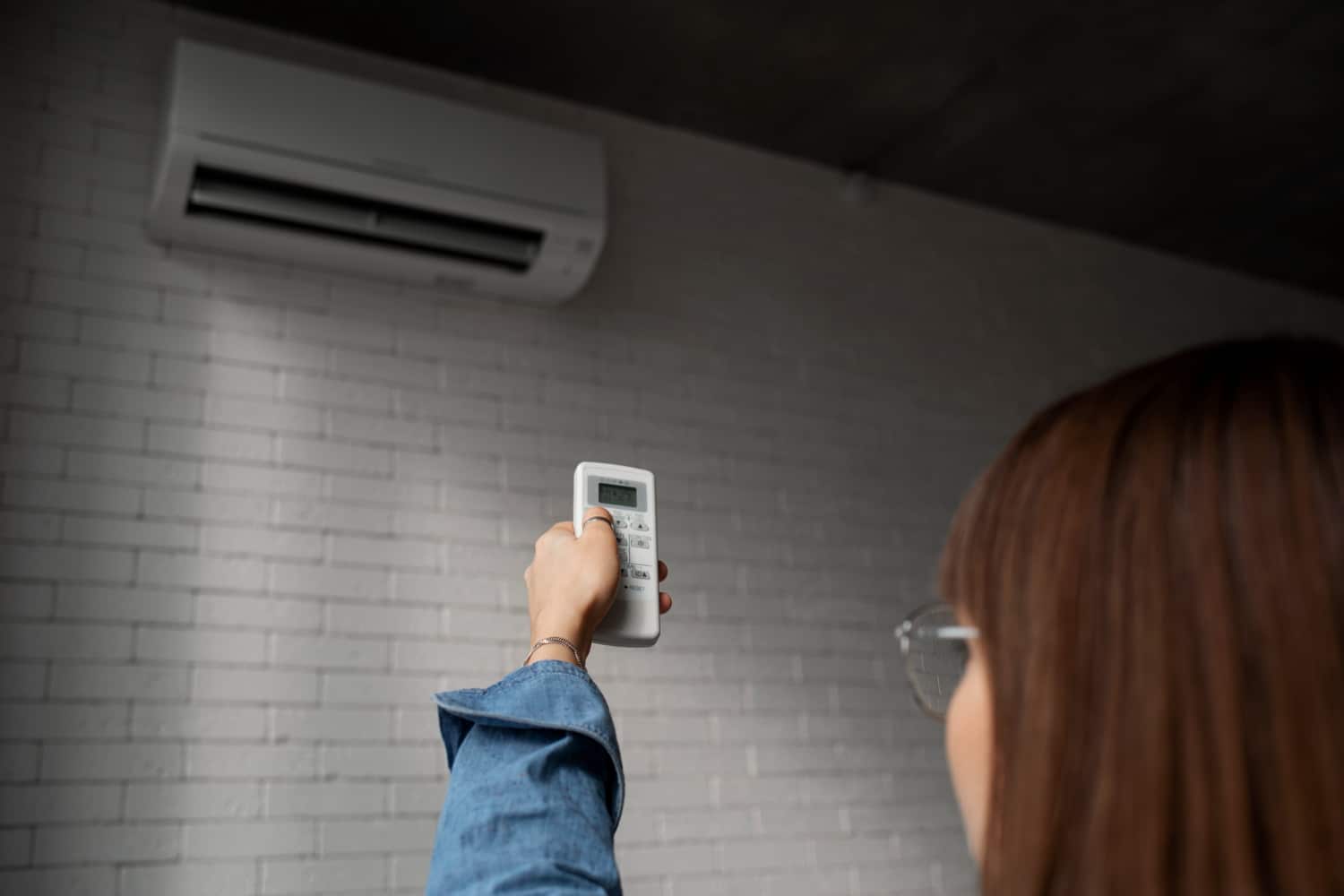woman turning ac on