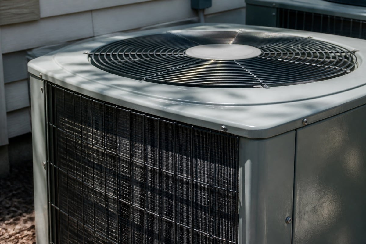 Close-up of a central air conditioner condenser fan and coil fins