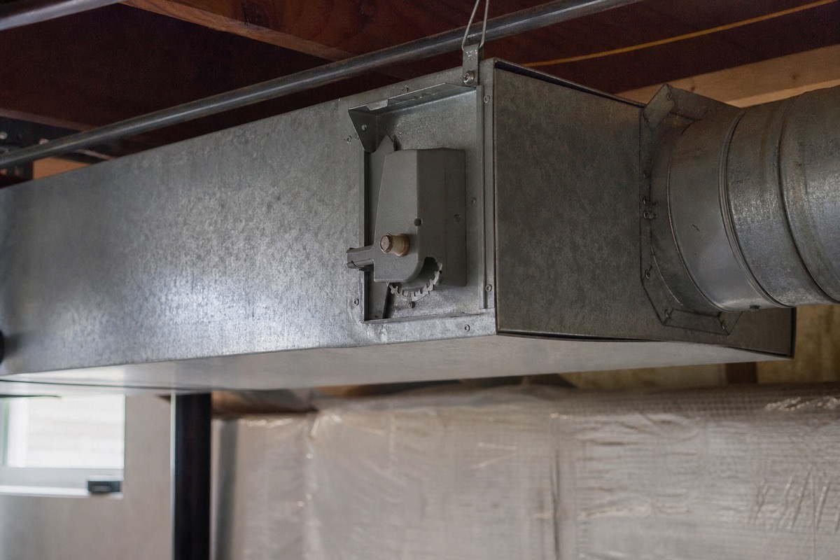 Close-up of an HVAC supply air duct with an inline damper