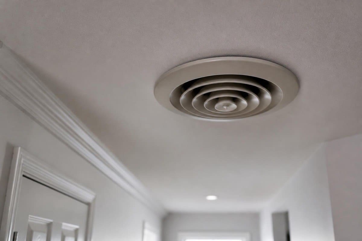 Clean HVAC vent register grille on a hallway ceiling after professional duct cleaning