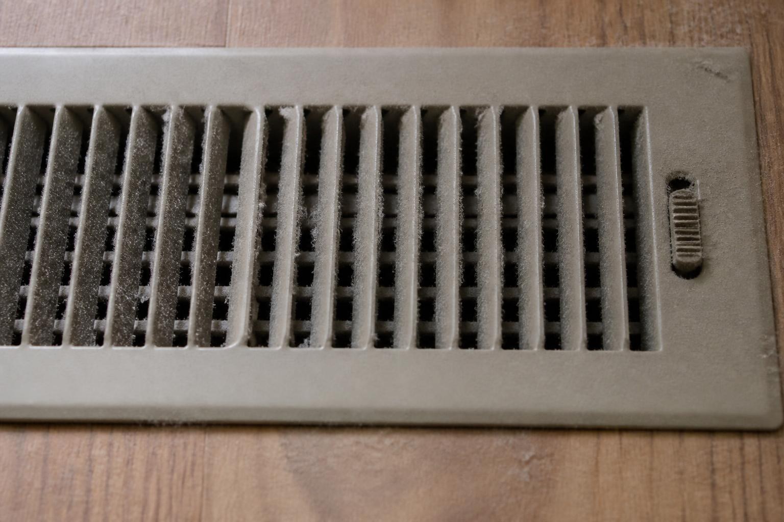 Close-up of a dusty floor air vent register due for duct cleaning