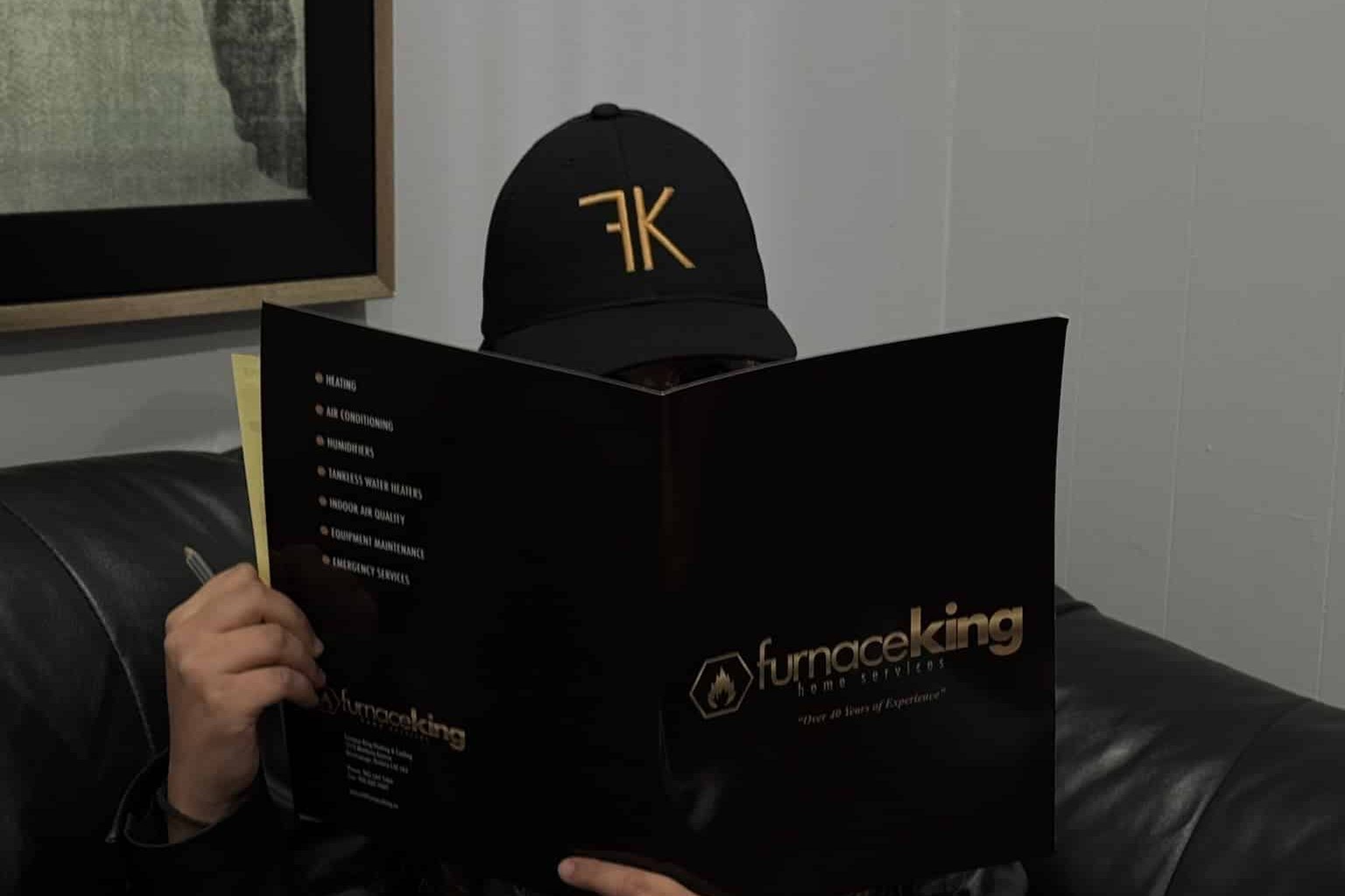 Furnace King team member reading the company service brochure