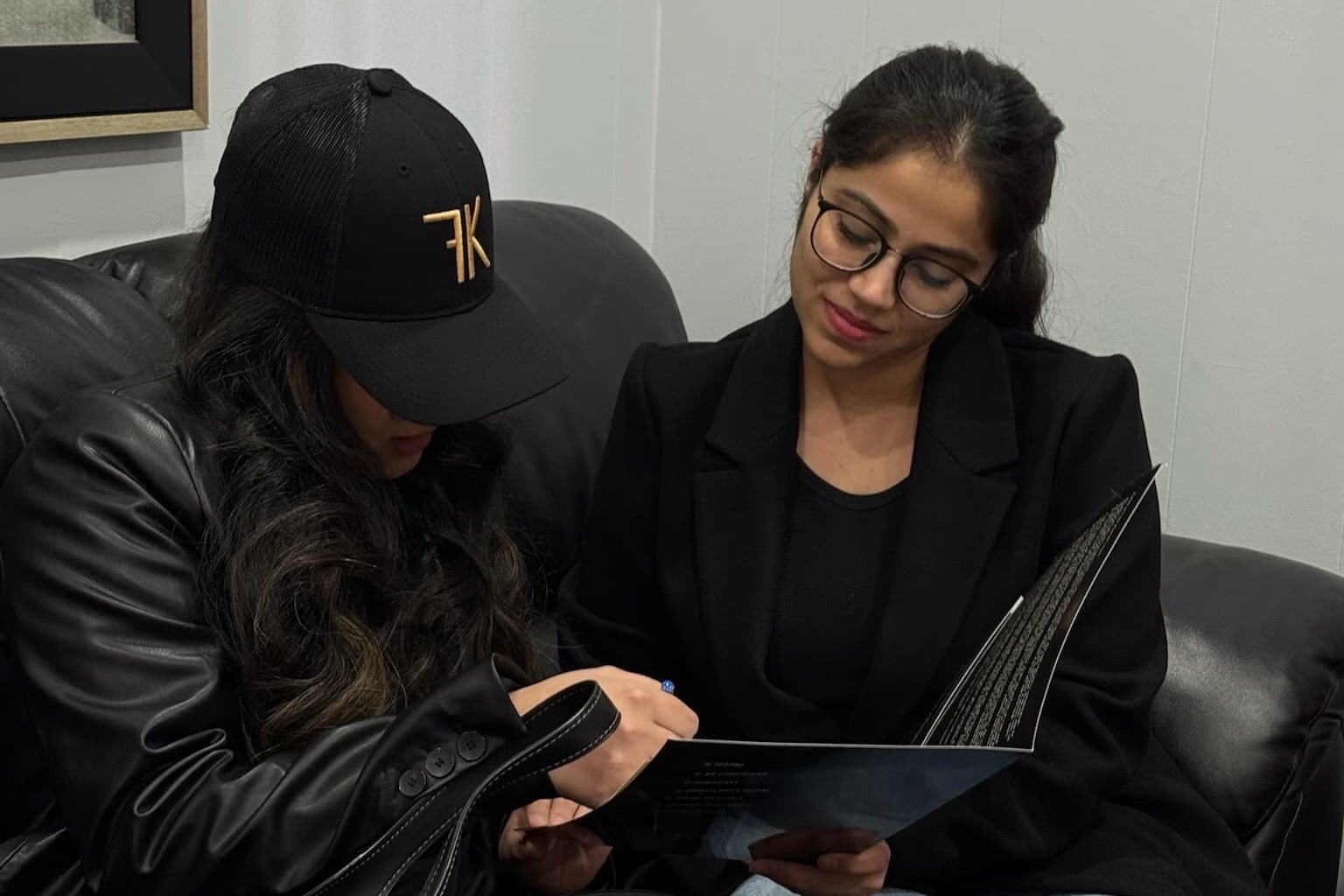 Two Furnace King team members looking through the company service brochure