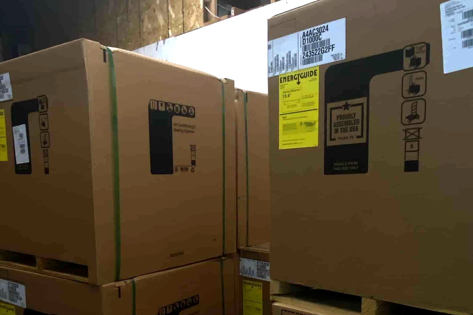Boxed air conditioning and heating equipment stacked in the Furnace King warehouse